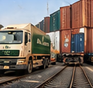 A delivery truck beside a goods train